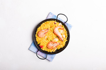 Traditional Spanish paella with seafood. Prepared in traditional pan