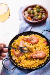 Traditional Spanish paella with seafood. Prepared in traditional pan
