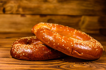 Bagels with sesame seeds on wooden table