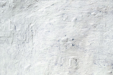 The uneven metal wall painted with white paint