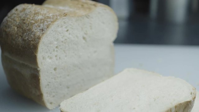 Prepareing toast in a home kitchen. Good quality bread and good quality butter. Cinematic lighting with suttle grading.