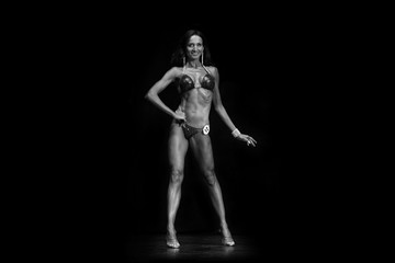 Obraz na płótnie Canvas tanned muscular fitness model in bikini