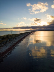 Obraz premium Aerial view of a beautiful beach on the Atlantic Ocean during a cloudy sunrise. Taken at Crescent Beach, Nova Scotia, Canada.