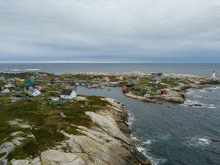 Aerial view of a small town near a rocky coast on the Atlantic Ocean. Taken in Peggy Cove, near Halifax, Nova Scotia, Canada.