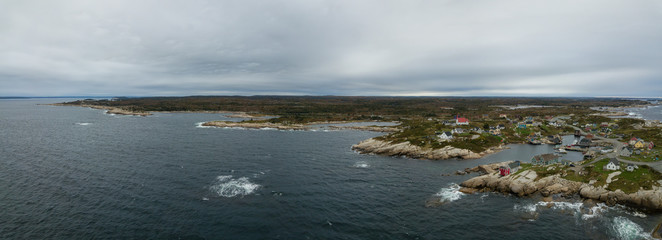 Aerial panoramic view of a small town near a rocky coast on the Atlantic Ocean. Taken in Peggy...