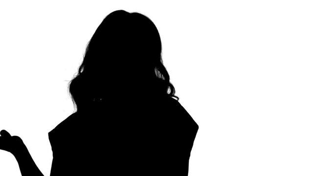Silhouette Female blonde woman talking to camera being very happy.
