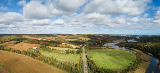 Aerial panoramic landscape view of Farm Fields during a sunny day. Taken near New Glasgow, Prince Edward Island, Canada.