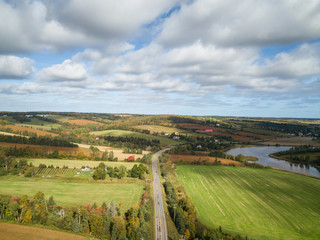 Fototapeta na wymiar Aerial panoramic landscape view of Farm Fields during a sunny day. Taken near New Glasgow, Prince Edward Island, Canada.