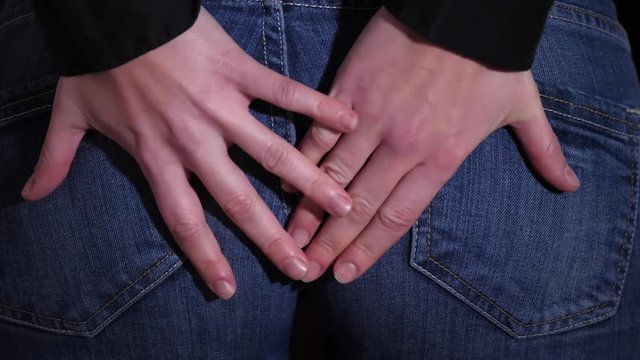 Sudden attack of anal pain and putting hands on a buttocks, massaging