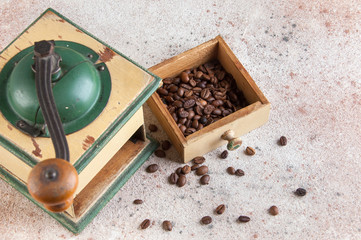 Fototapeta na wymiar Old wooden coffee grinder on concrete background.