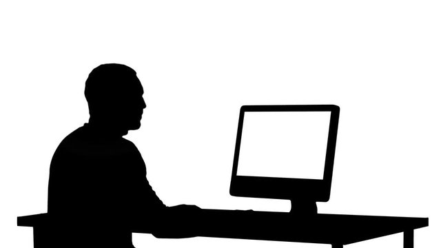Silhouette Man typing on the computer.