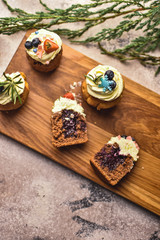 Handmade capcake with blueberries on wood background top view.