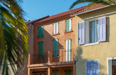 Fototapeta premium Colors of Provence, France, summertime in small city on Mediterranean Sea, colorful facades and windows and palm trees