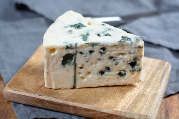 Roquefort soft French cheese made from sheep milk on  south of France, one of the world's best known blue cheeses with blue mold