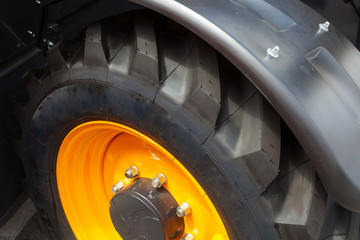 Close up side view photo of fragment huge tire wheel of construction or agriculture automotive...