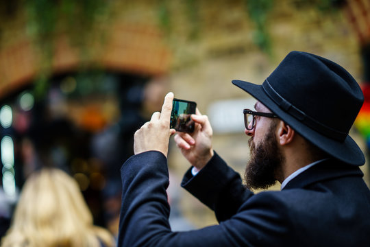 Beard handsome hipster taking photo with mobile phone, social media, 