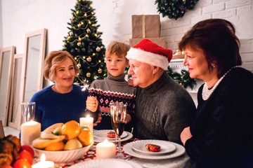 Grandparents celebrate new year's eve with their grandchildren at Christmas dinner
