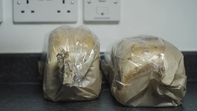 Prepareing toast in a home kitchen. Good quality bread and good quality butter. Cinematic lighting with suttle grading.