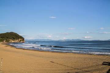 sea coast view with waves, sand beach and blue sky © kapichka