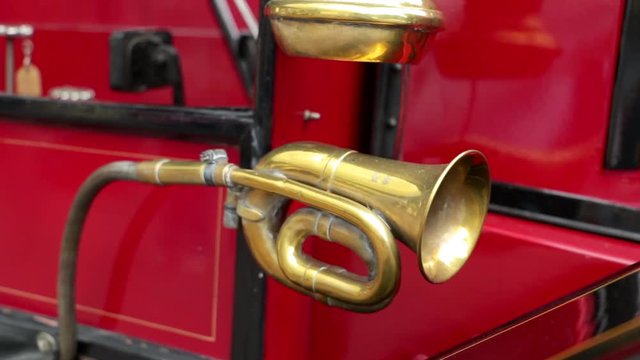 Close up shot of an old lantern and a brass horn on an oldtimer bus coach.