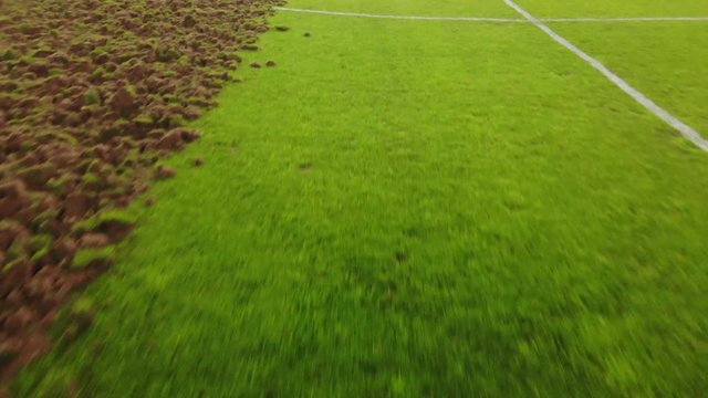 Drone shot of soccer pitch as it is being disked as part of the re-sodding process.