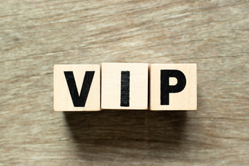 Letter block in word VIP (abbreviation of very important person) on wood background