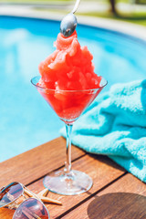 Preparation of Frozen Margarita or Daiquiry cocktail near the pool. Vacation, summer, holiday, luxury resort concept. Coral shade drink