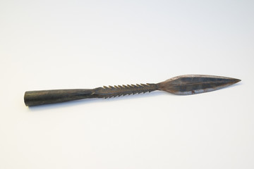 Old iron spearhead (spear), dating back to the 1980s, used by the nilotic tribes of South Sudan (Nuer, Dinka, Shilluk) isolated on a white background.  About 32 cm long.