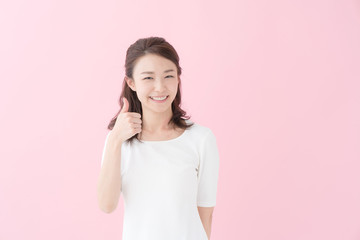 サムズアップ・女性・ピンクバック