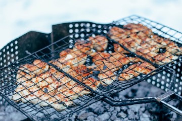 Chicken barbecue in the winter on the background of snow. Cooking meat in the cold.