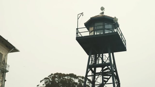 Alcatraz prison guard tower on cloudy day - tilt up shot, San Francisco, USA