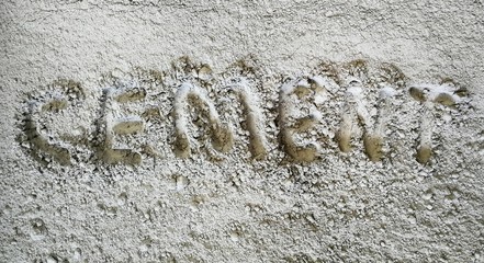 letter on cement powder on ground