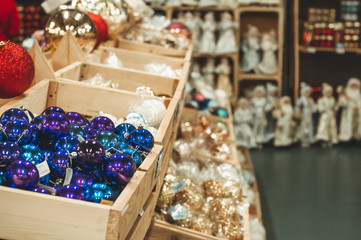 Sale of Christmas toys in the supermarket. Balls of different colors for the Christmas tree on the supermarket shelves. 