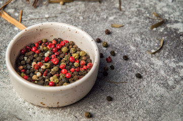 Close up. A beige bowl filled with colorful mix peppercorns. Copy space.