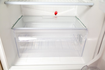 transparent box stands bottom of  empty refrigerator © glebchik