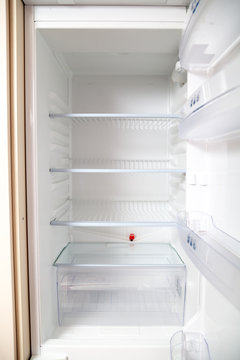 empty open refrigerator close-up