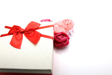 Gift box isolated on the white background present with red bow with silver sparkles. Festive backdrop for holidays. Birthday, Valentines day, Christmas, New Year. Flat lay style