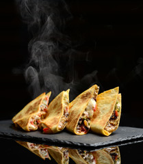Mexican Quesadilla wrap with chicken   sweet pepper sour cream and salsa hot with steam smoke