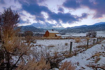 Old wooden barn in a winter landscape