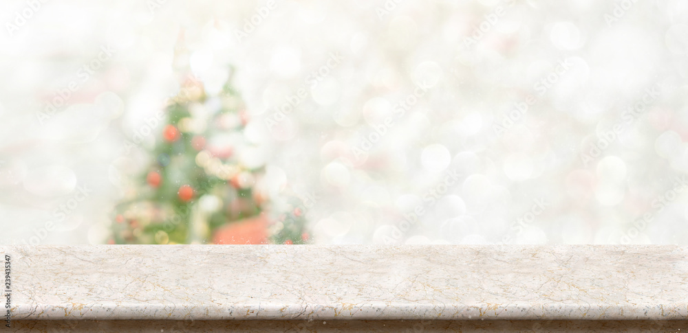 Aufkleber White marble table top at blur bokeh christmas tree decor with string light background when show falling,Winter holiday greeting card.