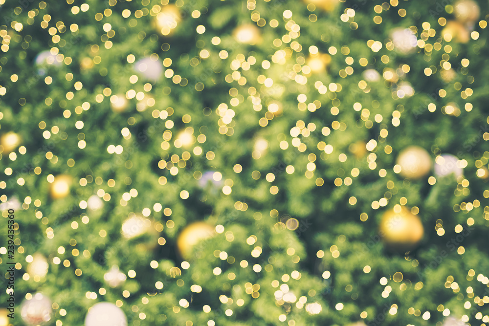 Poster Abstract blur decoration ball and light string on christmas tree with bokeh light background.winter holiday seasonal.