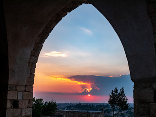 Golden sunset shinning through an ancient arch