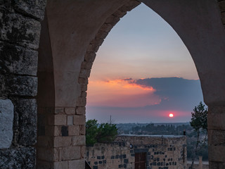 Golden sunset shinning through an ancient arch