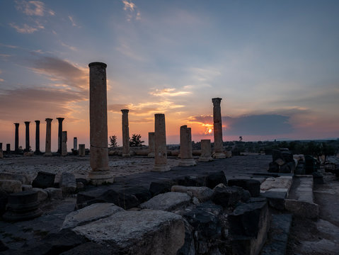 Pillars of a Roman temple against a a golden sunset