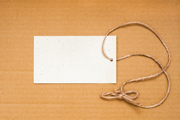 Paper label with rope on brown background. Empty