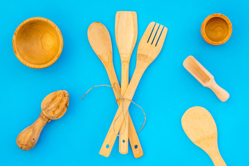 Village wooden cutlery set on blue background top view