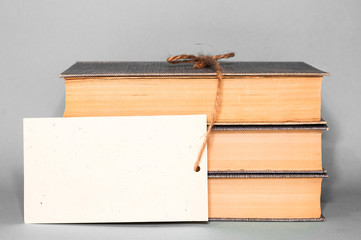 Books and empty card with rope on gray background. Packaging with space for text. Close