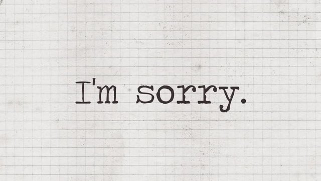 Typewriter characters appearing on an old paper sheet, composing the phrase: I'm sorry (with a full stop).