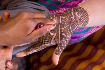applying henna on hand, Hindu wedding ,Rajasthan, India