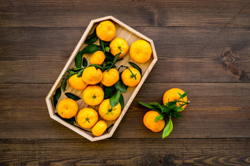 pile of tangerines for New Year and Christmas celebration on wooden background top view